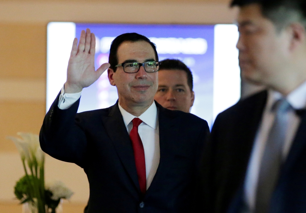 US Treasury Secretary Steven Mnuchin waves to the media as he and the U.S. delegation for trade talks with China, leave a hotel in Beijing, China May 3, 2018. REUTERS/Jason Lee