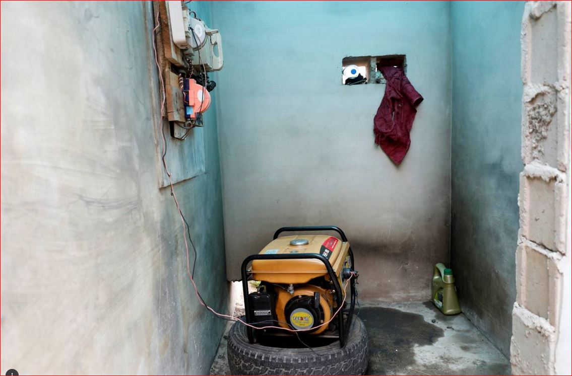 A generator is connected to electric sockets pinned to a wall in a house in Ikeja district in Nigeria's commercial capital Lagos, August 10, 2017. Reuters/Akintunde Akinleye