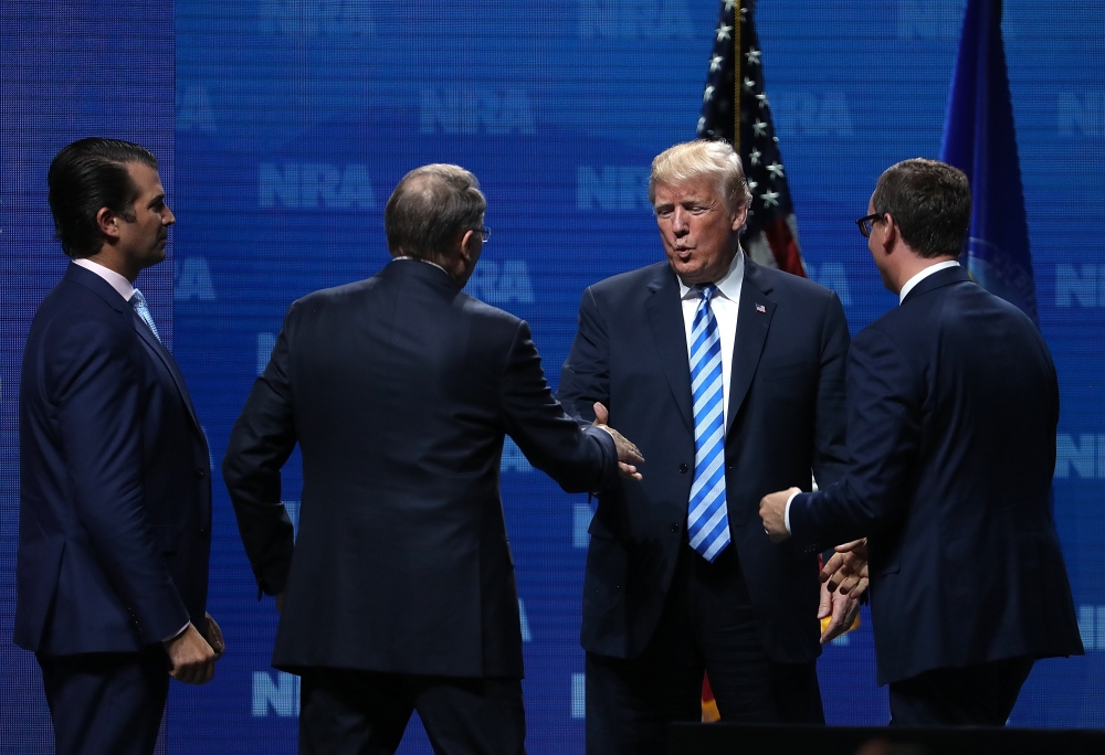 Donald Trump Jr., NRA Executive Vice President Wayne LaPierre, U.S. President Doanld Trump and Executive Director NRA-ILA Chris Cox shake hands at the NRA-ILA Leadership Forum during the NRA Annual Meeting & Exhibits at the Kay Bailey Hutchison Convention