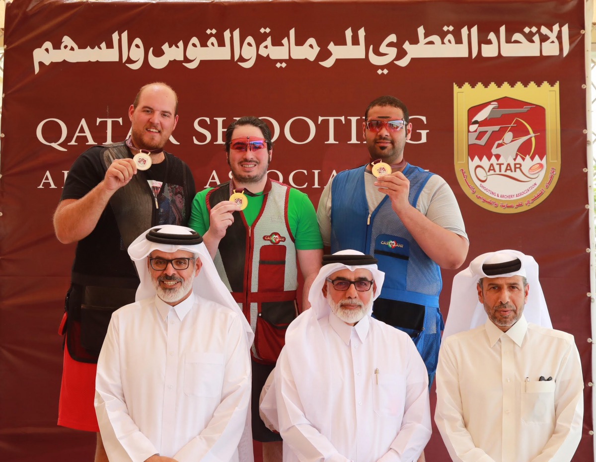 Mohammed Dablan (centre), Angelo Scalzone (left) and Mohamed Al Rumaihi, podium winners at the Qatar Cup Shooting and Archery Championship, pose for a picture along with the Organising Committee Chairman Jaber Al Hajri, Tournament Director Abdullah Al Ham