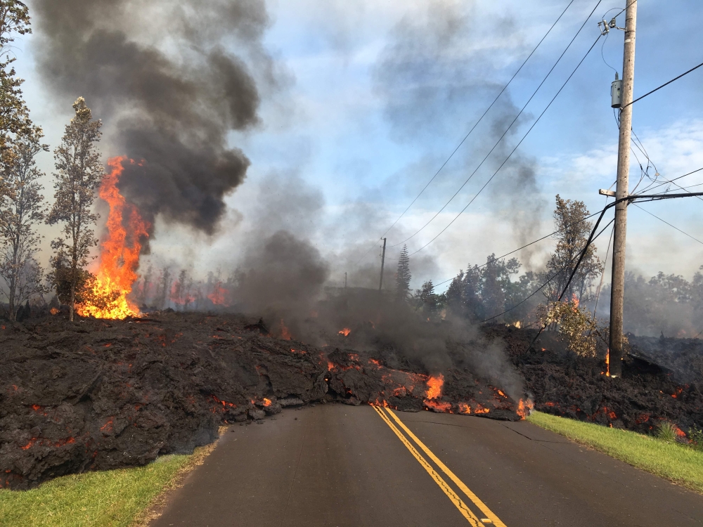 This image released by the US Geological Survey shows lava from a fissure slowly advancing to the northeast on Hookapu Street in Leilani Estates, Hawaii, on May 5, 2018. AFP PHOTO / US Geological Survey/HO