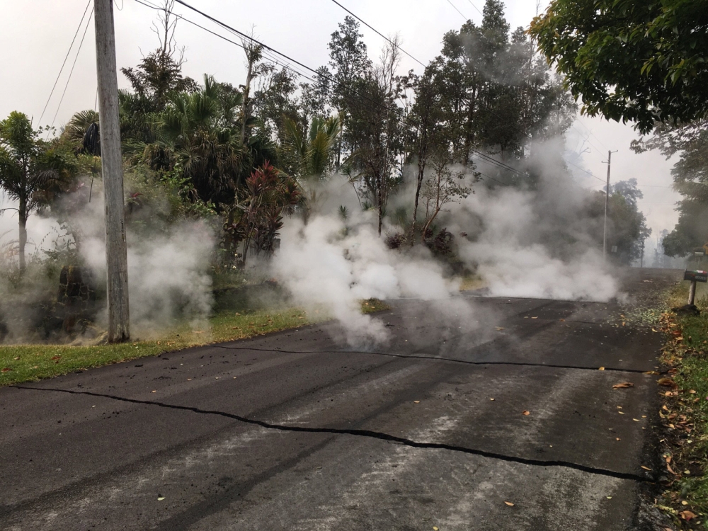 Steam rises from fissure 9 on Moku Street in the Leilani Estates subdivision, in Hawaii, U.S. May 7, 2018. Picture taken on May 7, 2018. USGS/Handout via REUTERS