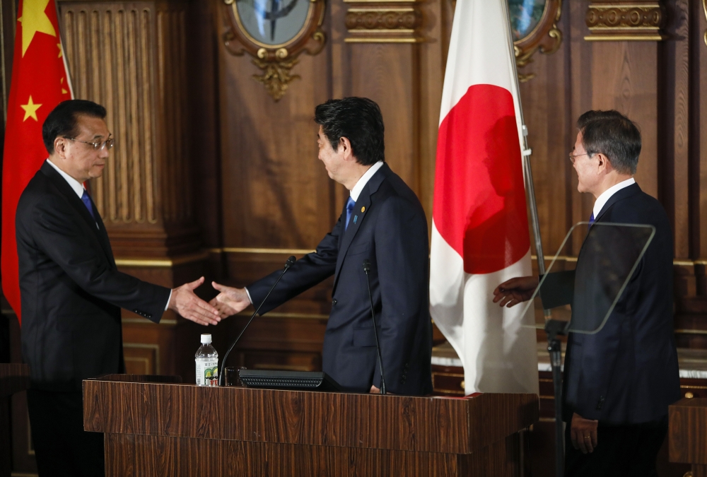Chinese Premier Li Keqiang (C - L), Japanese Prime Minister Shinzo Abe (C) and South Korean President Moon Jae-in (C - R) attend the trilateral summit in Tokyo Wednesday, May 9, 2018. ( KIMIMASA MAYAMA / Anadolu 
