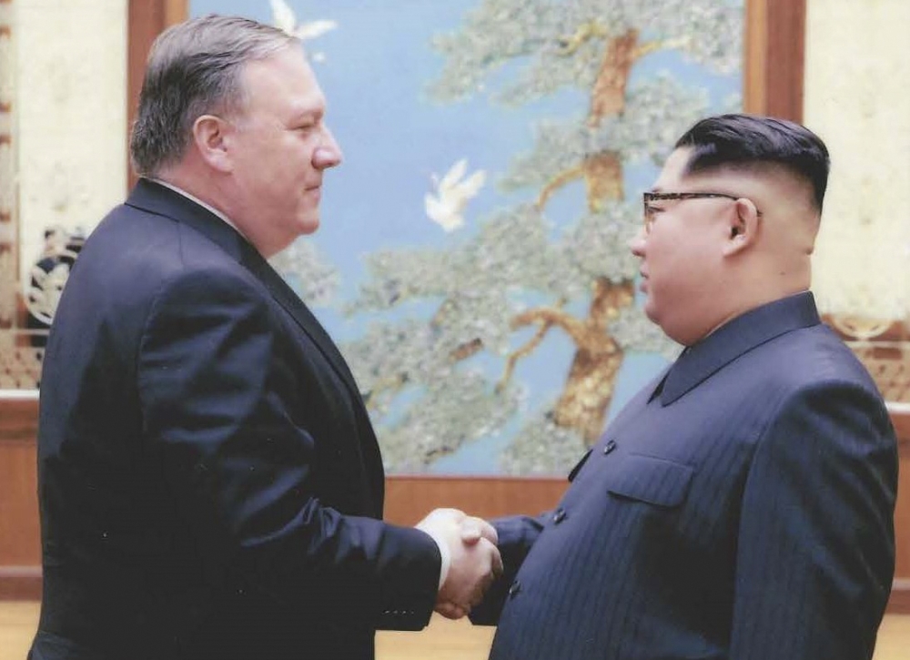 (FILES) In this file photo released by the US Government on April 26, 2018, North Korean leader Kim Jong-Un (R) shakes hands with the former CIA Director, now US Secretary of State, Mike Pompeo in Pyongyang over the 2018 Easter weekend. / AFP / US Governm
