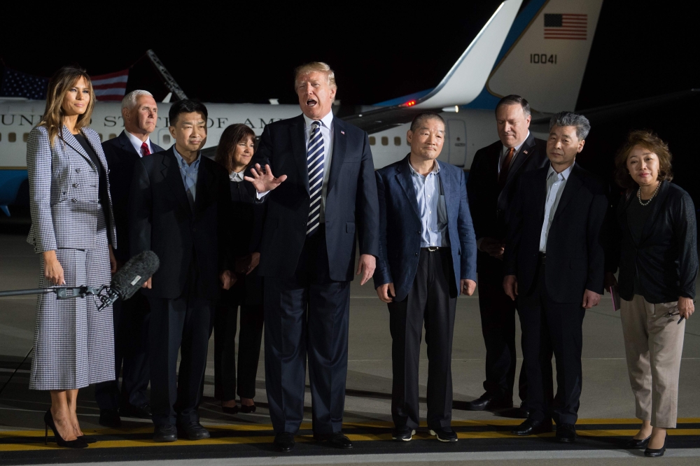 US President Donald Trump (C) speaks upon the arrival of US detainees Kim Dong-chul (4th R), Kim Hak-song (2nd R) and Tony Kim (3rd L) after they were freed by North Korea, at Joint Base Andrews in Maryland on May 10, 2018. AFP / SAUL LOEB