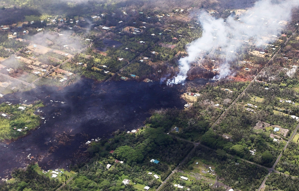 Smoke and volcanic gases rise as lava cools in the Leilani Estates neighborhood, in the aftermath of eruptions and lava flows from the Kilauea volcano on Hawaii's Big Island, on May 11, 2018 in Pahoa, Hawaii. Mario Tama/Getty Images/AFP
