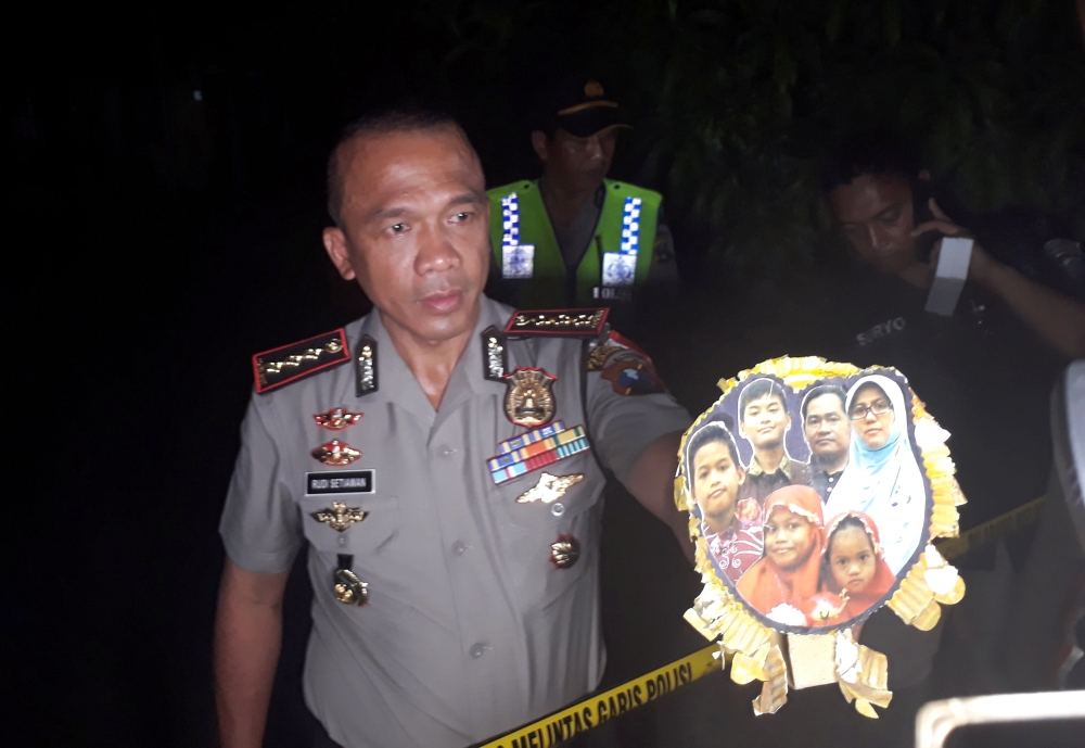Chief of Surabaya Police, Rudi Setiawan, shows a family photo of suspected suicide bombers of the three churches in Surabaya, following a raid at their home in Surabaya, East Java, Indonesia, May 13, 2018 in this photo taken by Antara Foto. Antara Foto/Na