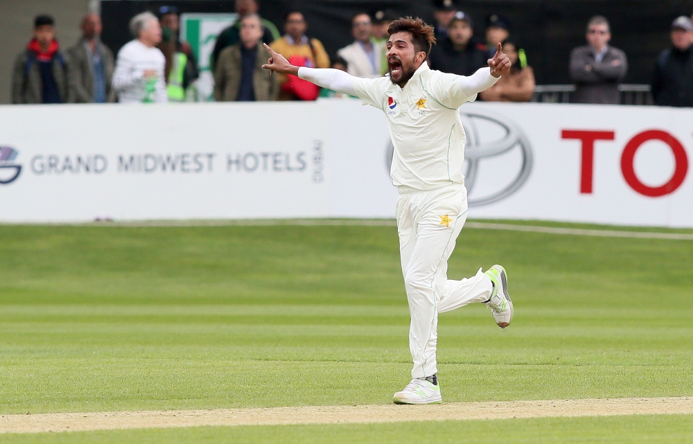 Pakistan's Mohammad Amir celebrates taking the wicket of Ireland's Niall O'Brien for 18 runs during play on day four of Ireland's inaugural test match against Pakistan at Malahide cricket club, in Dublin on May 14, 2018. AFP / Paul Faith 