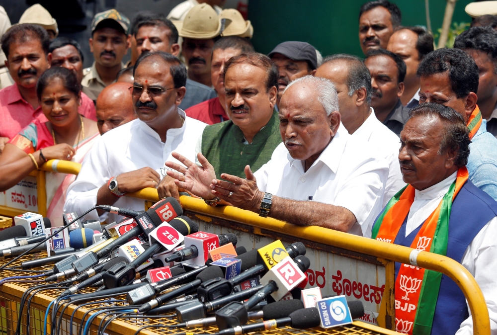 India's ruling Bharatiya Janata Party (BJP) leader and former Chief Minister of the southern state of Karnataka B. S. Yeddyurappa speaks with the media after meeting with the state governor to stake claim to form the government, outside the governor's hou