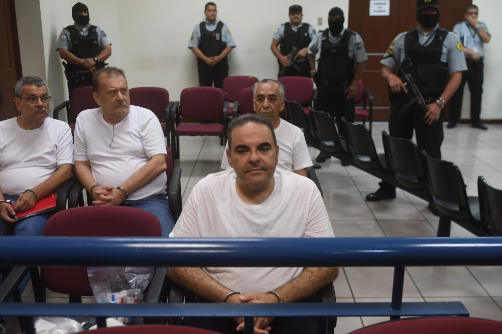 Former Salvadoran President (2004-2009) Elias Antonio Saca, along with six of his collaborators, waits for the judge to arrive in court in San Salvador on May 16, 2018, to face charges of embezzlement and laundering for allegedly diverting 298 million dol