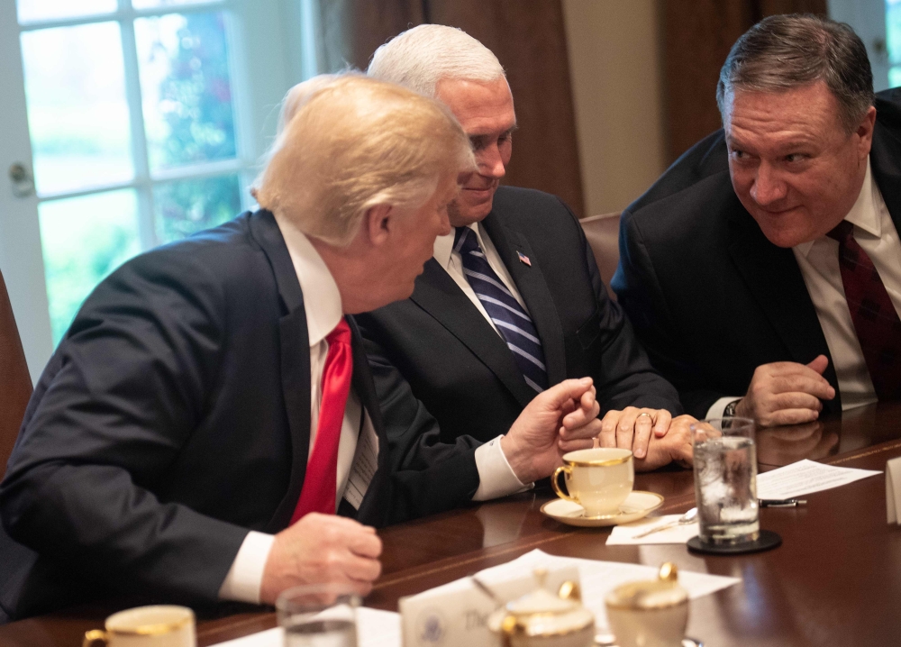 US President Donald Trump speaks (R) with Secretary of State Mike Pompeo as Vice President Mike Pence (C) looks on during a meeting with NATO Secretary General Jens Stoltenberg in the Cabinet Room at the White House in Washington, DC, on May 17, 2018. AFP