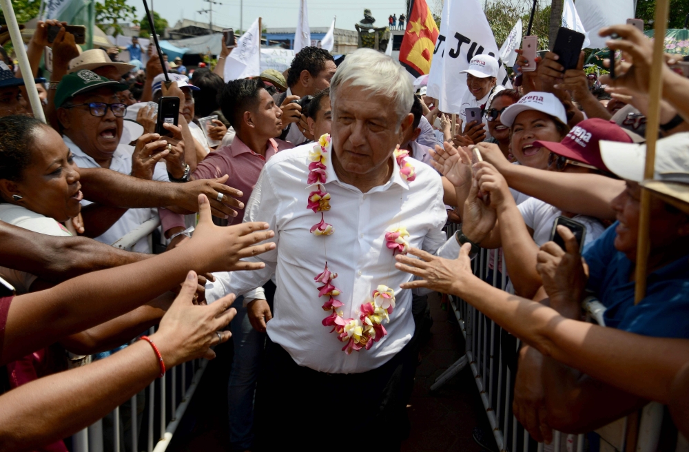Mexico's presidential candidate for the MORENA party, Andres Manuel Lopez Obrador, greets supporters during a meeting at San Marcos community, in Guerrero State, Mexico on May 17, 2018. AFP / FRANCISCO ROBLES