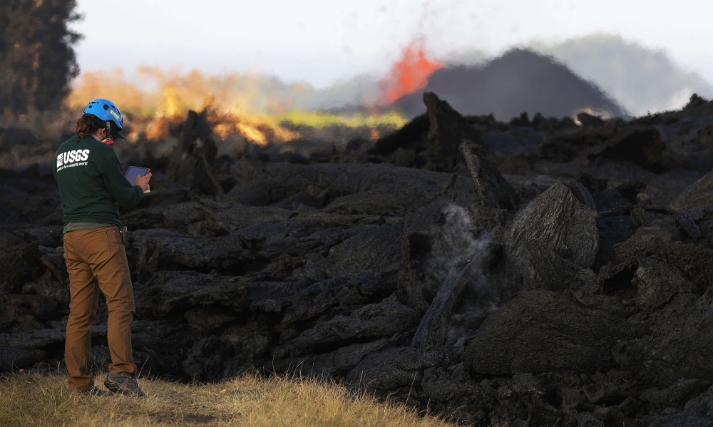 A USGS (US Geological Survey) geologist inspects a recent Lava flow from a Kilauea volcano fissure on Hawaii's Big Island on May 19, 2018 in Kapoho, Hawaii. Mario Tama/Getty Images/AFP