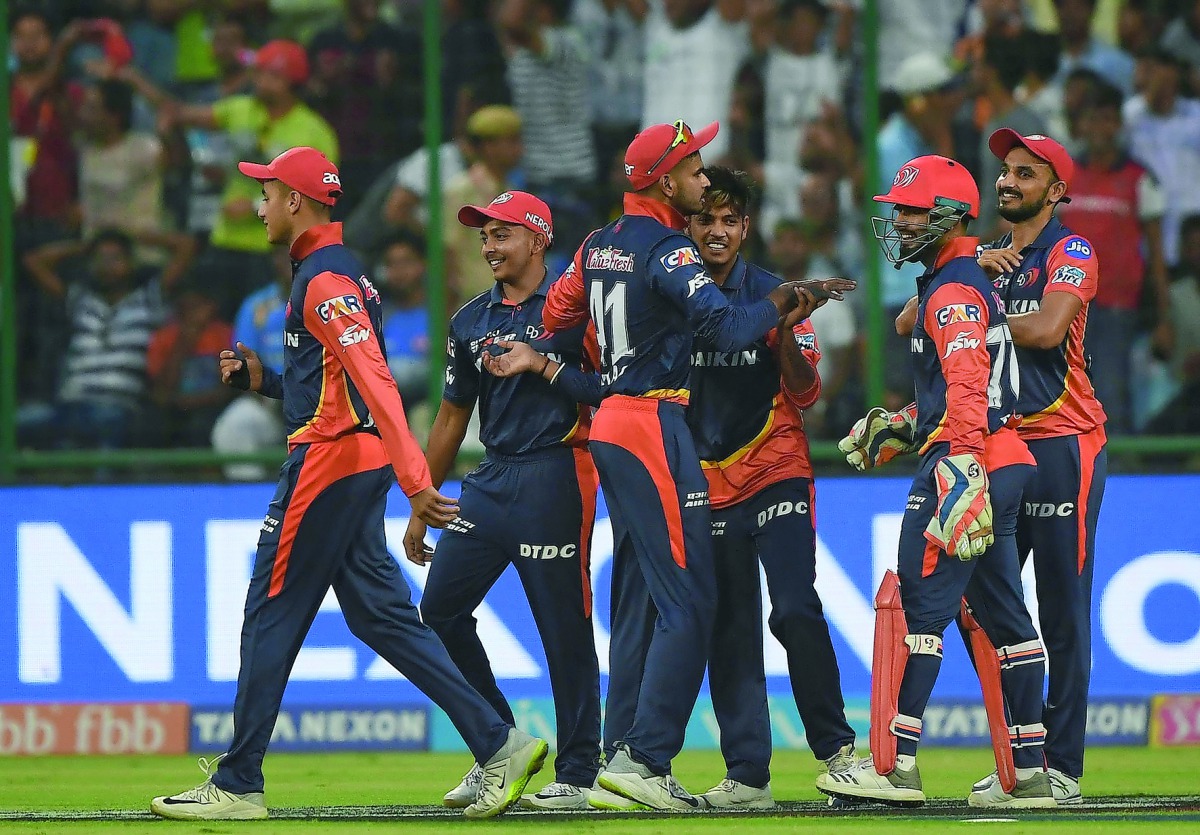 Delhi Daredevils cricketer Sandeep Lamichhane (3R) celebrates the wicket of Mumbai Indians cricketer Krunal Pandya with teammates during the 2018 Indian Premier League (IPL) Twenty20 cricket match between Delhi Daredevils and Mumbai Indians at the Feroz S