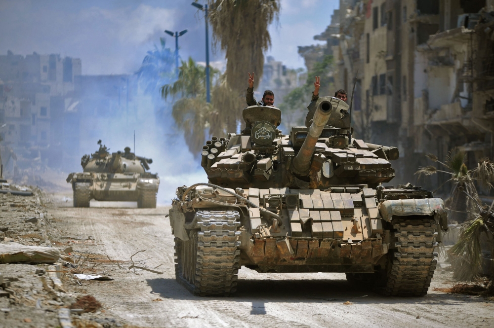 A handout picture released by the official Syrian Arab News Agency (SANA) on May 14, 2018 shows government forces head towards jihadist positions in the Hajar al-Aswad district on the southern outskirts of Damascus. AFP PHOTO / HO / SANA