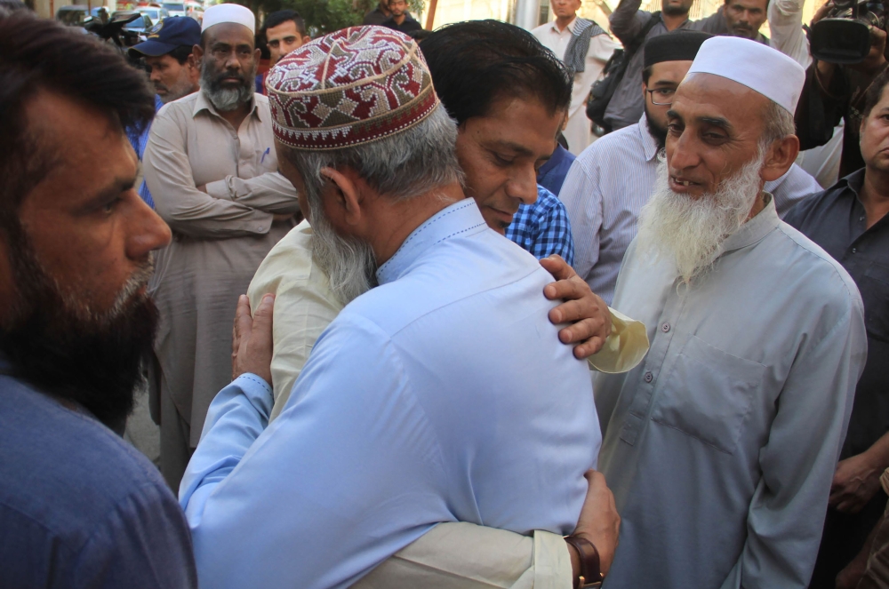 Abdul Aziz (2R), father of slain Pakistani exchange student Sabika Sheikh, who was killed during a school shooting in Texas, meets with people during his daughter's funeral in Karachi on May 23, 2018. AFP / IMRAN ALI
