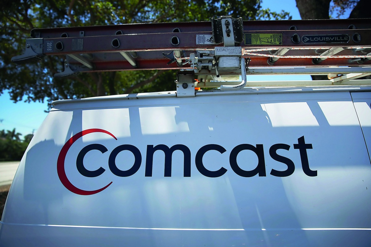 
In this file photo taken on April 25, 2018 a Comcast sign is seen on a truck in Miami, Florida. US cable operator Comcast said May 23, 2018 it is preparing an all-cash offer to beat out Disney for the purchase of 21st Century Fox assets up for sale.  AF