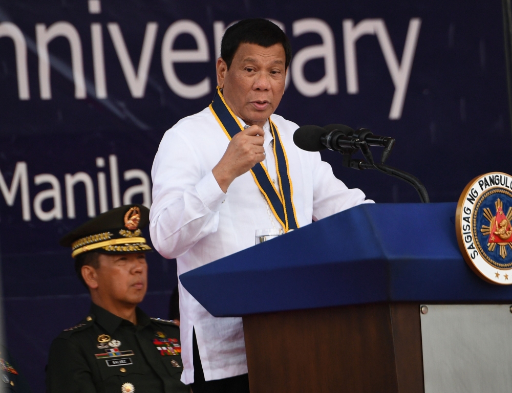 Philippine President Rodrigo Duterte delivers his speech during the 120th Philippine navy anniversary celebration in Manila on May 22, 2018. / AFP / TED ALJIBE