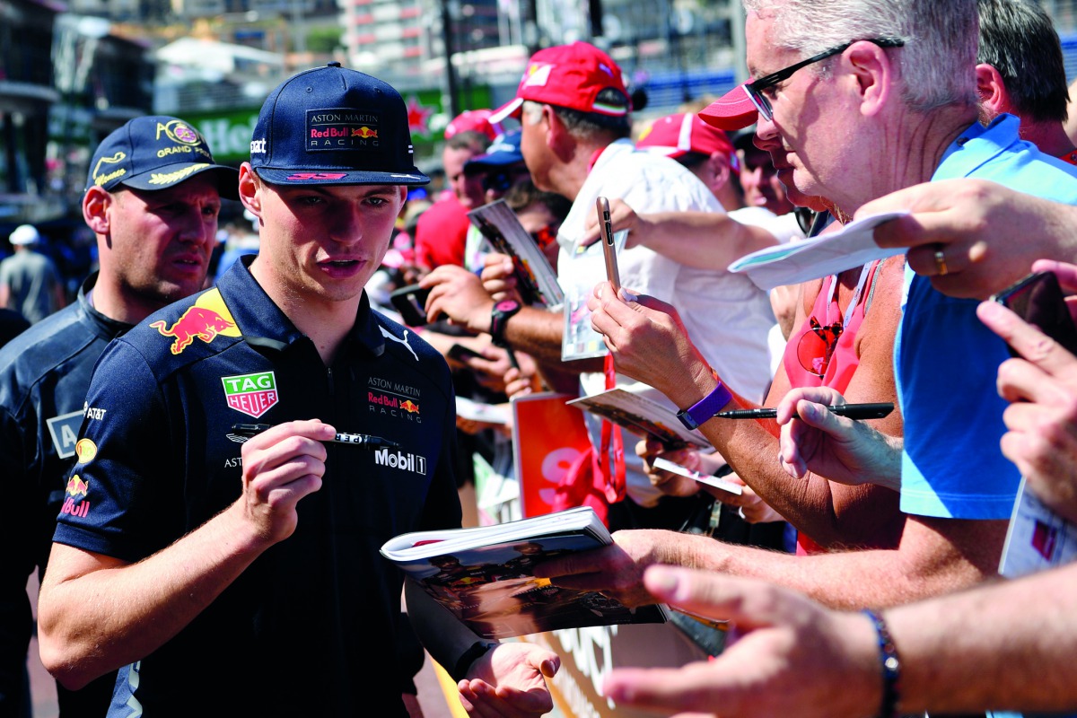 Red Bull's Dutch driver Max Verstappen signs autographs to F1 fans during an autograph session at the pit lane of the Monaco street circuit on May 25, 2018 in Monaco, ahead of the Monaco Formula 1 Grand Prix. AFP / Andrej Isakovic