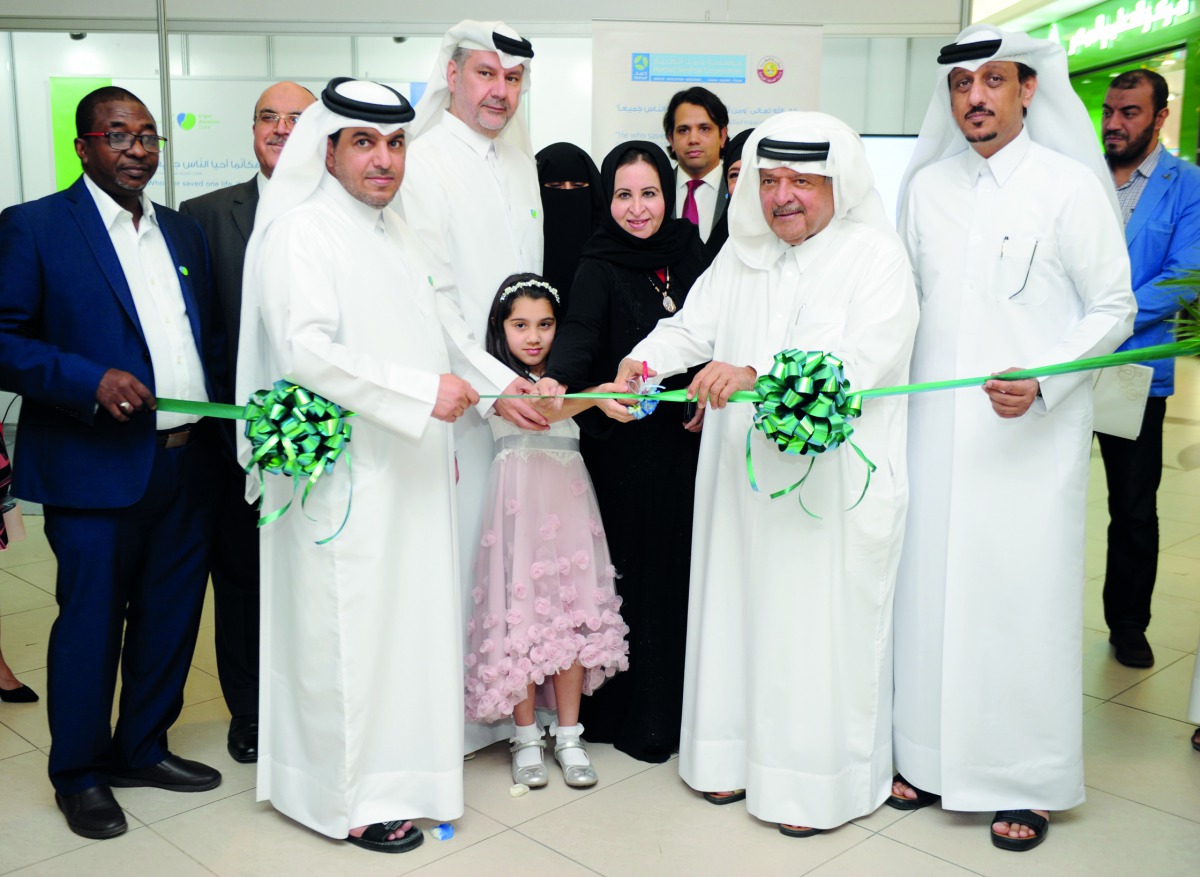Sheikh Faisal bin Qassim Al Thani (second right), Founder and Chairman of Al Faisal Without Borders Foundation (ALF), cutting a ribbon with Siddiqa Al Mahmoudi (third right), Medical Manager of HMC’s Blood Donor Center, Dr  Abdulla Al Ansari (third left),