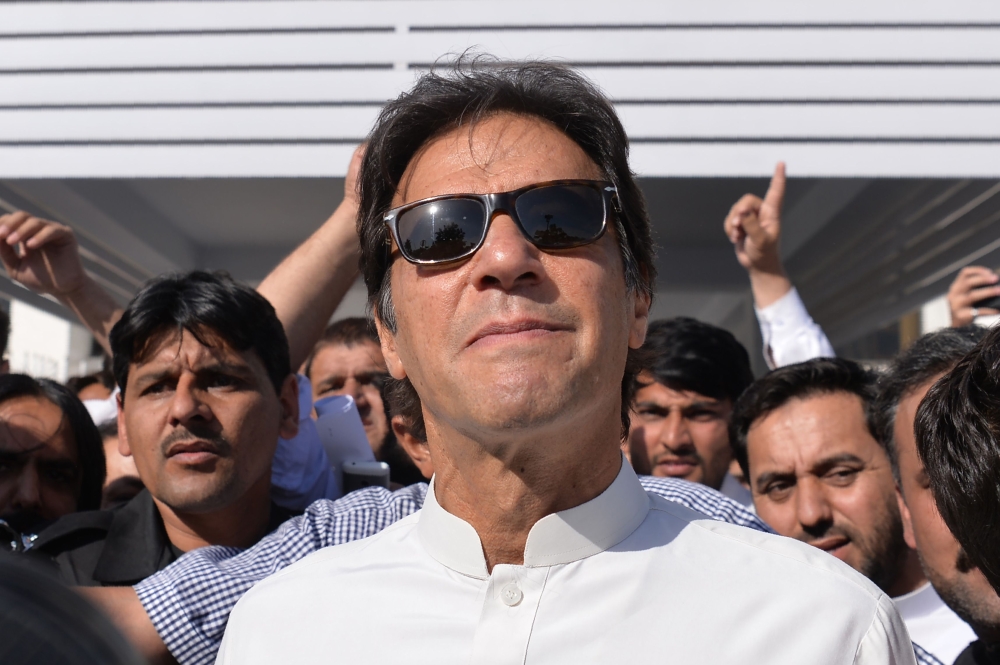 Pakistan opposition leader and head of the Pakistan Tehreek-e-Insaf (PTI - Pakistan Movement for Justice) political party Imran Khan leaves Parliament after attending a session in Islamabad on May 23, 2018. AFP / AAMIR QURESHI