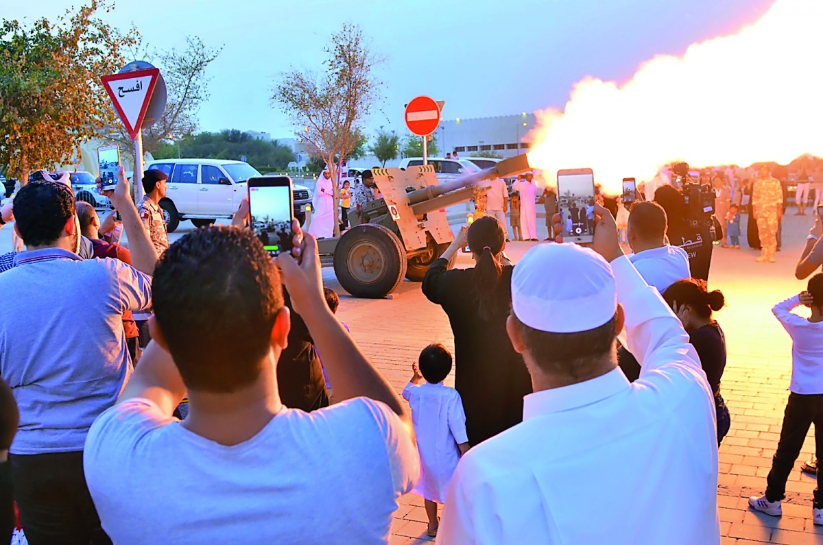 People taking pictures of cannon firing.