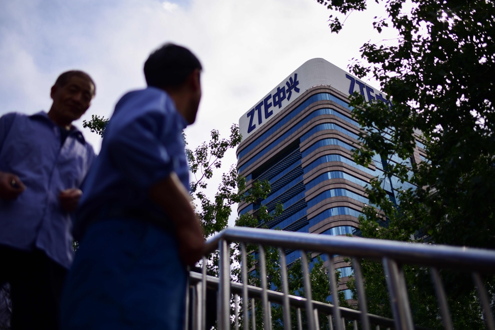 In this file photo taken on May 2, 2018 The ZTE logo is seen on a building in Beijing. / AFP / WANG ZHAO 