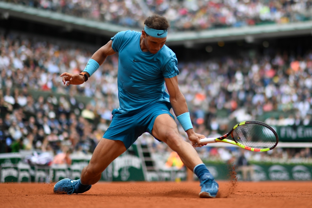 Spain's Rafael Nadal plays a backhand return to Italy's Simone Bolelli during their men's singles first round match on day three of The Roland Garros 2018 French Open tennis tournament in Paris on May 29, 2018. (AFP / CHRISTOPHE SIMON)