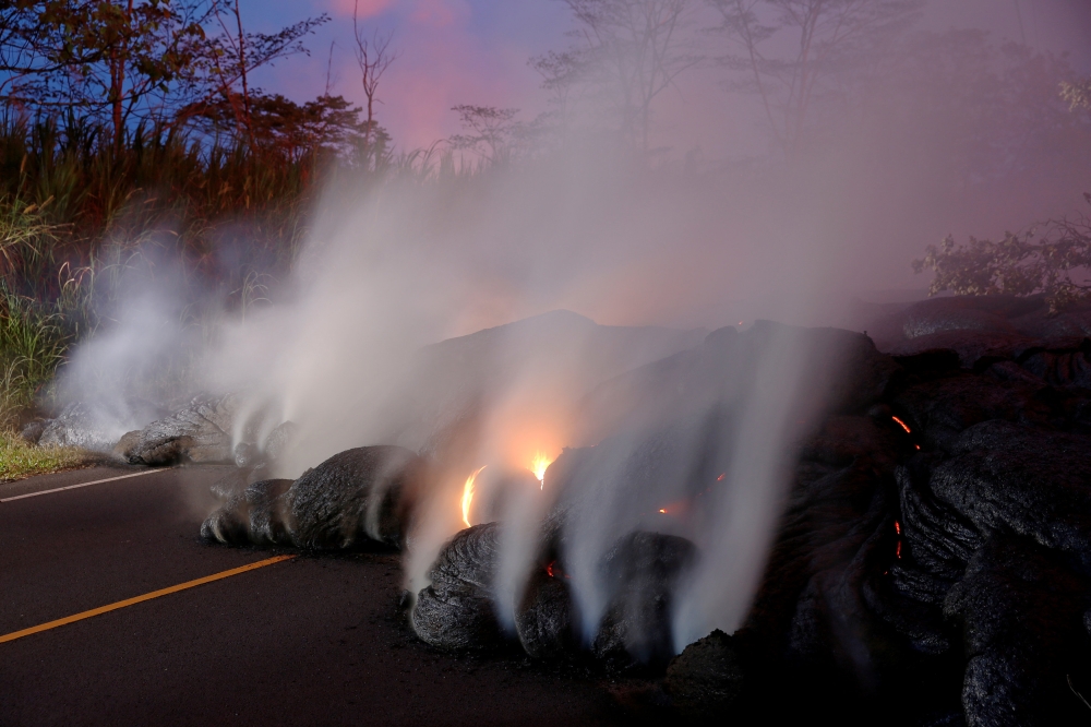 Volcanic gases rise from the Kilauea lava flow that crossed Pohoiki Road near Highway 132, near Pahoa, Hawaii, US, May 28, 2018. REUTERS/Marco Garcia 