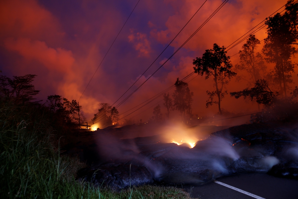 Volcanic gases rise from the Kilauea lava flow that crossed Pohoiki Road near Highway 132, near Pahoa, Hawaii, US, May 28, 2018. REUTERS/Marco Garcia