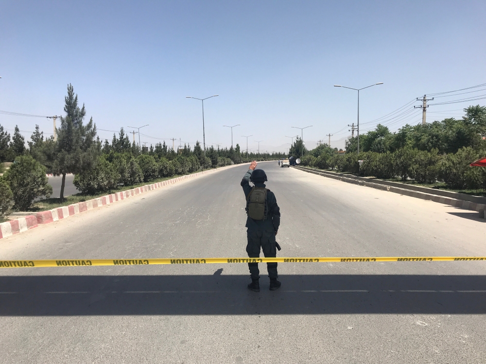 An Afghan policeman keeps watch near the site of an attack and gunfire in Kabul, Afghanistan May 30, 2018. REUTERS/Mohammad Ismail