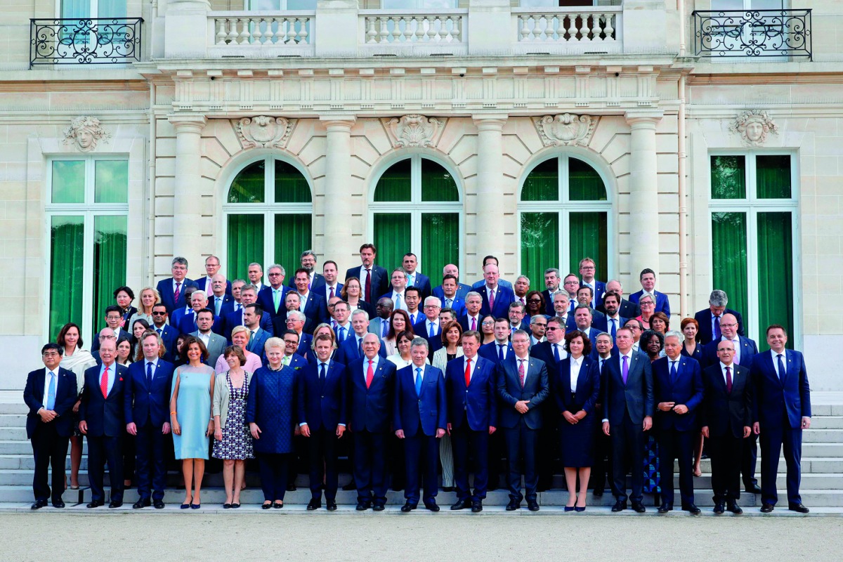 Organisation for Economic Co-operation and Development (OECD) Secretary-General Angel Gurria, French President Emmanuel Macron, Lithuania's President Dalia Grybauskaite and Colombia's President Juan Manuel Santos pose for a family photo with heads of dele