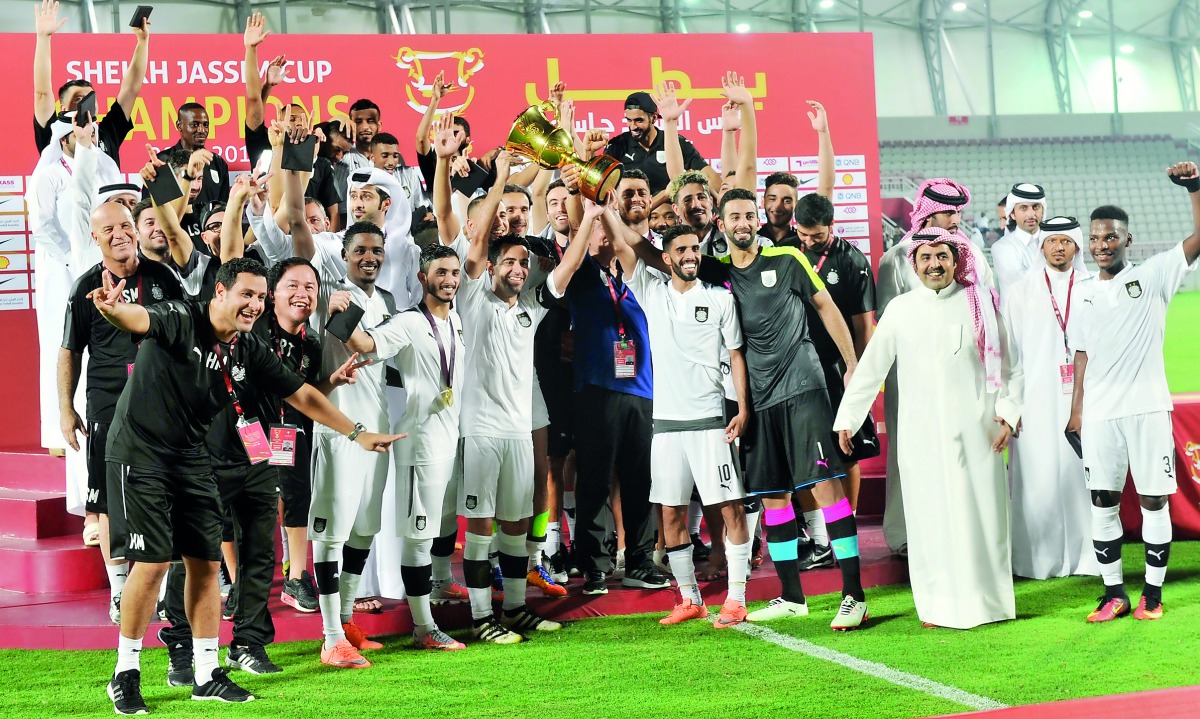 Al Sadd’s players and officials celebrate on the podium with the trophy after winning the 2017 Sheikh Jassim Cup at Al Duhail Stadium in this file photo.