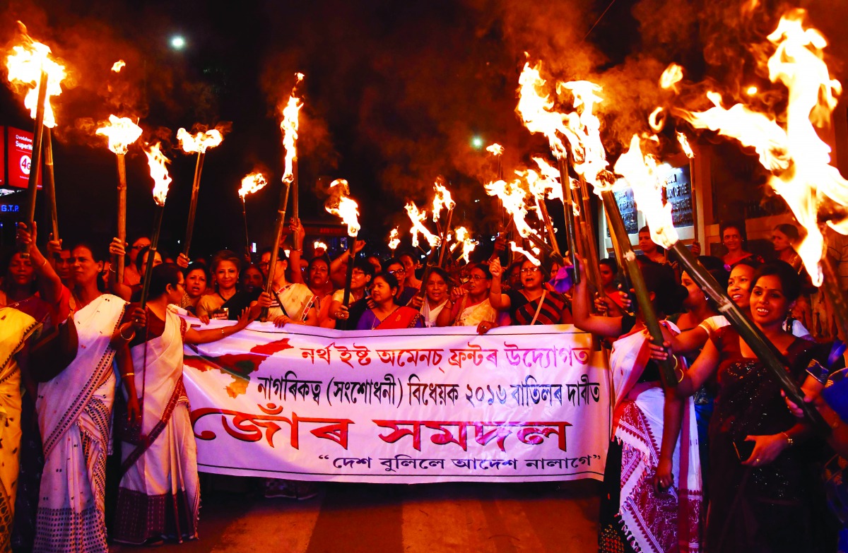 Activists of the North East Women Front (NEWF) take part in a torch light procession in protest against the Citizenship (Amendment) Bill 2016 proposal to provide citizenship or stay rights to minorities from Bangladesh, Pakistan and Afghanistan in India, 