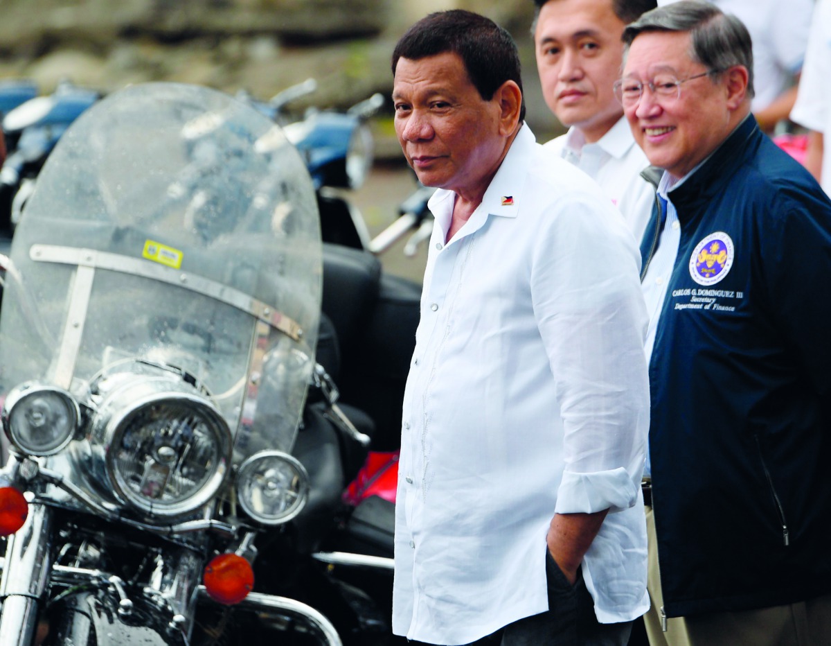 Philippine President Rodrigo Duterte (L) attends a ceremony where seized vehicles and motorcycles were destroyed at the customs yard in Manila on May 30, 2018. AFP / Ted Aljibe