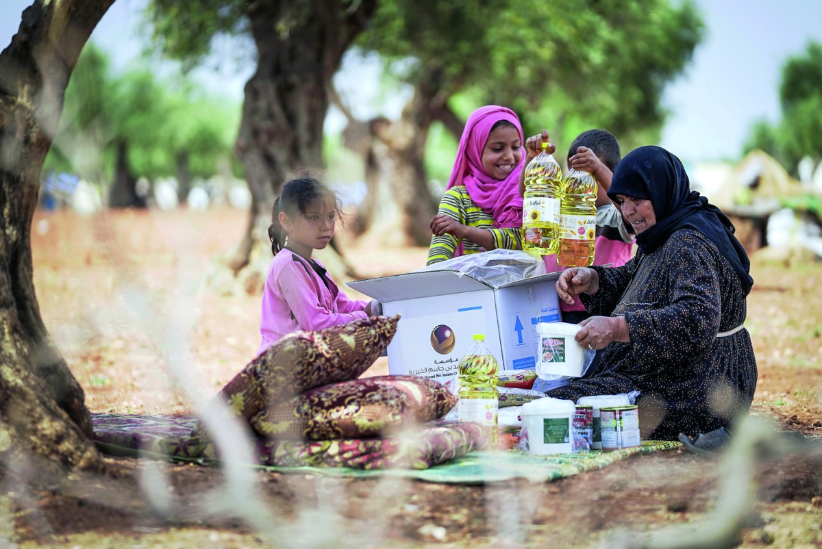 HBJ Foundation brought smile to the face of a Syrian woman by providing food basket.