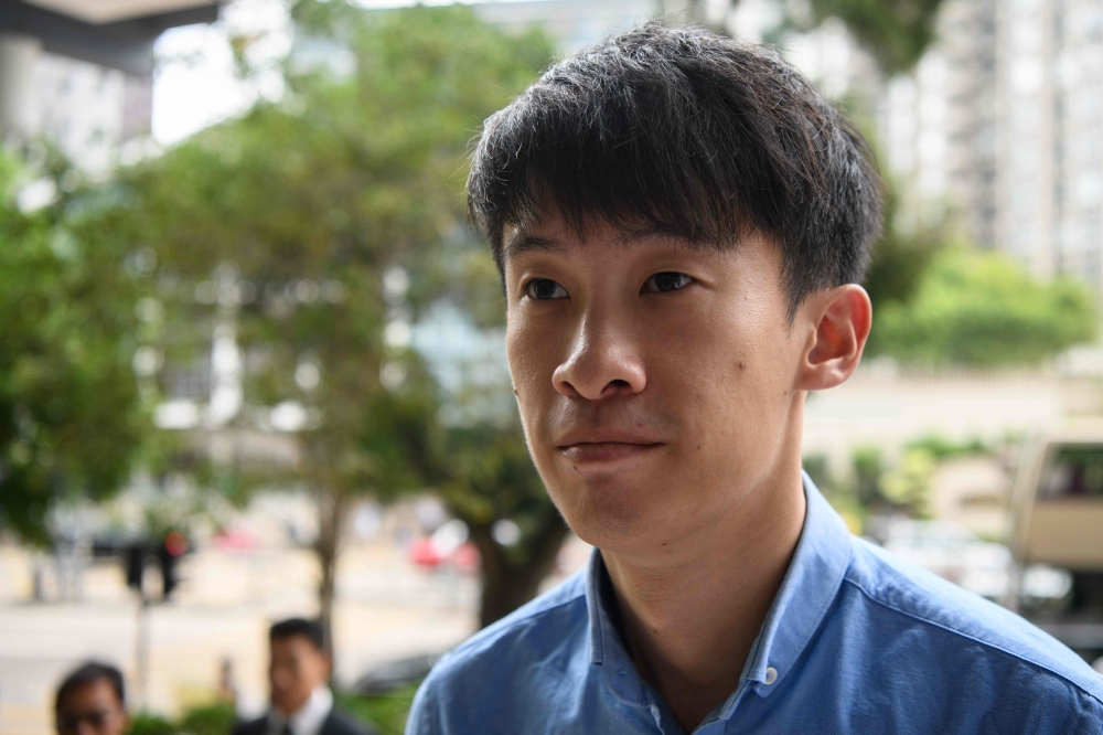 Disqualified lawmaker Baggio Leung arrives at the Kowloon City Magistrates Court in Hong Kong on June 4, 2018, for his sentencing after he was found guilty of unlawful assembly. / AFP / Anthony WALLACE 
