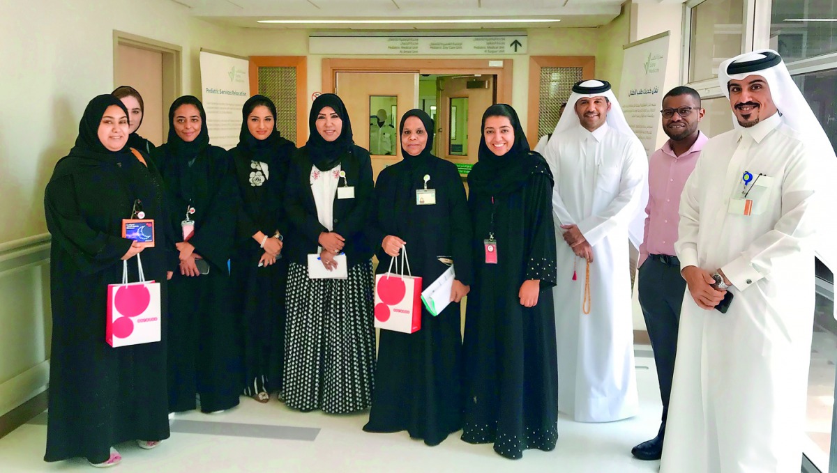 Manar Khalifa Al Muraikhi, Director of PR and Corporate Communications of Ooredoo, with Ooredoo volunteers, during the visit to Hamad General Hospital’s children’s ward. 