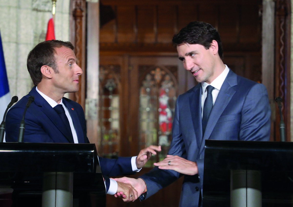 Canadian Prime Minister Justin Trudeau (R) and French President Emmanuel Macron (L)shake hands during a joint press conference at Parliament on June 7, 2018 in Ottawa. Macron and Canadian Prime Minister Justin Trudeau expressed support for 