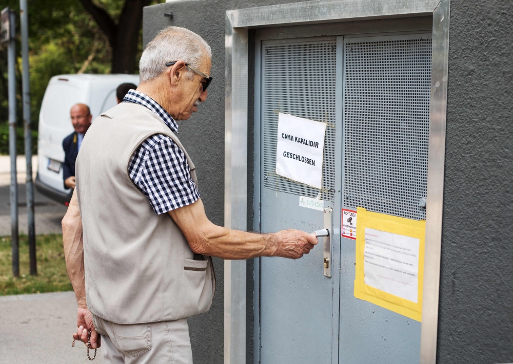 A community member tries to open the door of the 