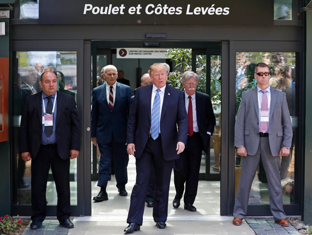 U.S. President Donald Trump speaks while in front of a restaurant sign that reads 