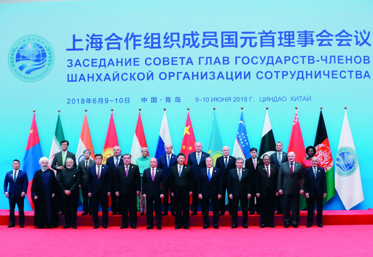 Russian President Vladimir Putin during a photo session of the SCO Heads of State, heads of observer nations and leaders of international organisations ahead of an expanded format meeting of the SCO Council of Head of State in Qingdao. From left, front ro