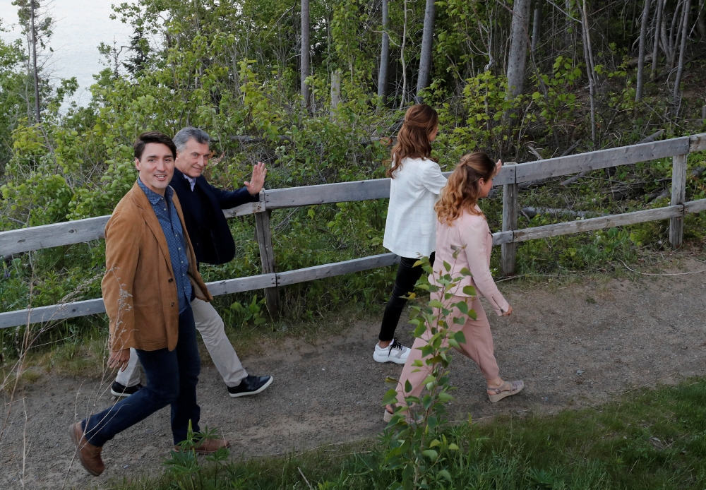 Canada's Prime Minister Justin Trudeau and his wife Sophie Gregoire Trudeau walk with Argentina's President Mauricio Macri and his wife Juliana Awada Macri during a G7 Summit in the Charlevoix town of La Malbaie, Quebec, Canada, June 9, 2018. REUTERS/Yves