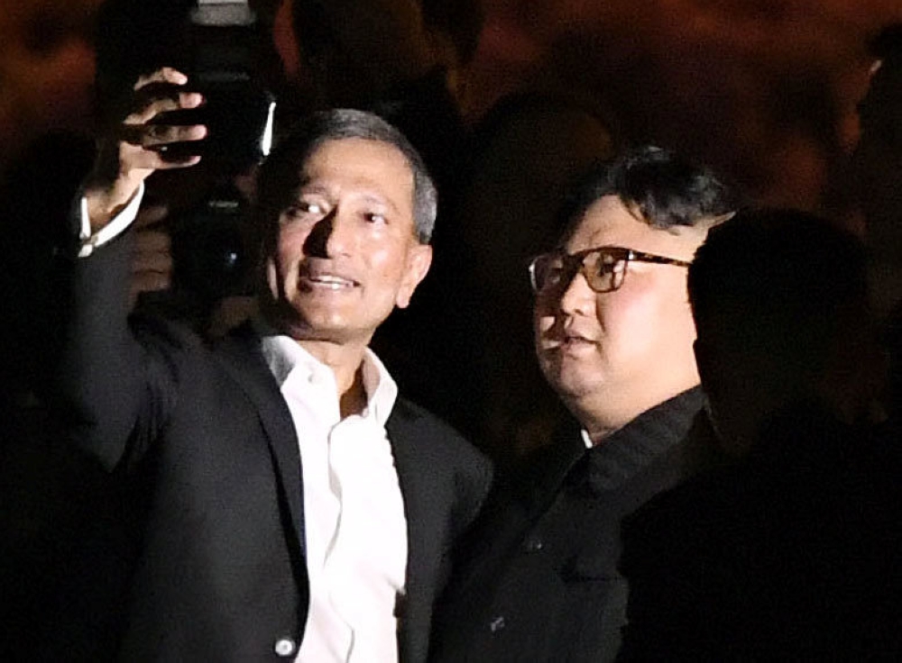 Singapore's Foreign Minister Vivian Balakrishnan takes a selfie with North Korea's leader Kim Jong Un during a visit in Merlion Park in Singapore, in this photo taken by Kyodo June 11, 2018. Kyodo/via Reuters