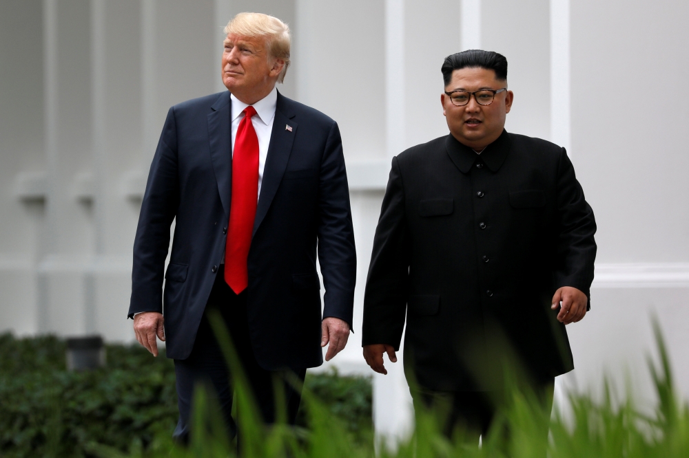 US President Donald Trump and North Korean leader Kim Jong Un walk after lunch at the Capella Hotel on Sentosa island in Singapore June 12, 2018. REUTERS/Jonathan Ernst