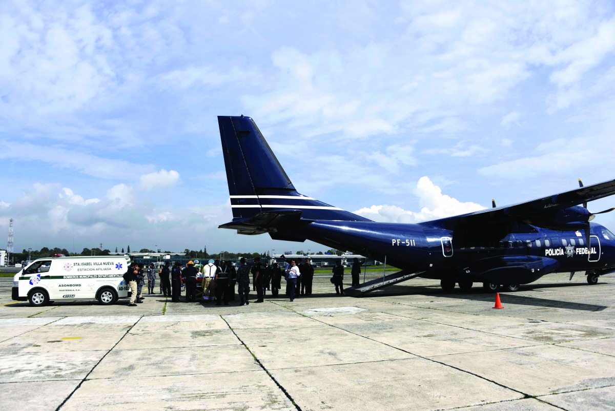 A person sereverly burnt during the Fuego volcano eruption is carried onto a plane of the Mexican Federal Police before departing for Mexico to receive specialized treatment, at the Guatemalan Air Force (FAG) base in Guatemala City on June 12, 2018. More 