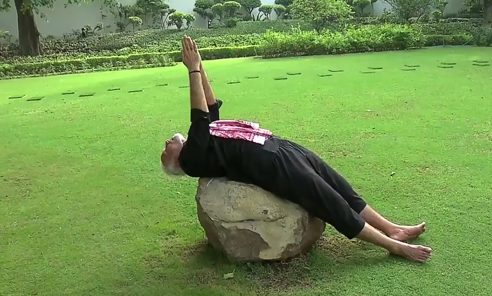 This screenshot taken from a video posted on India Prime Minister twitter handle, shows Indian Prime Minister Narendra Modi performing Yoga following a fitness challenge in New Delhi on June 13, 2018. AFP 