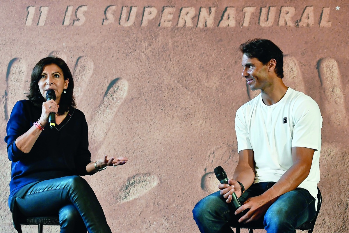 Spain's tennis player Rafael Nadal listens to Paris' mayor Anne Hidalgo during a press conference at the Paris city hall on June 11, 2018, a day after he won his 11th French Open title in Roland Garros and 17th grand slam title. AFP / Stephane De Sakutin