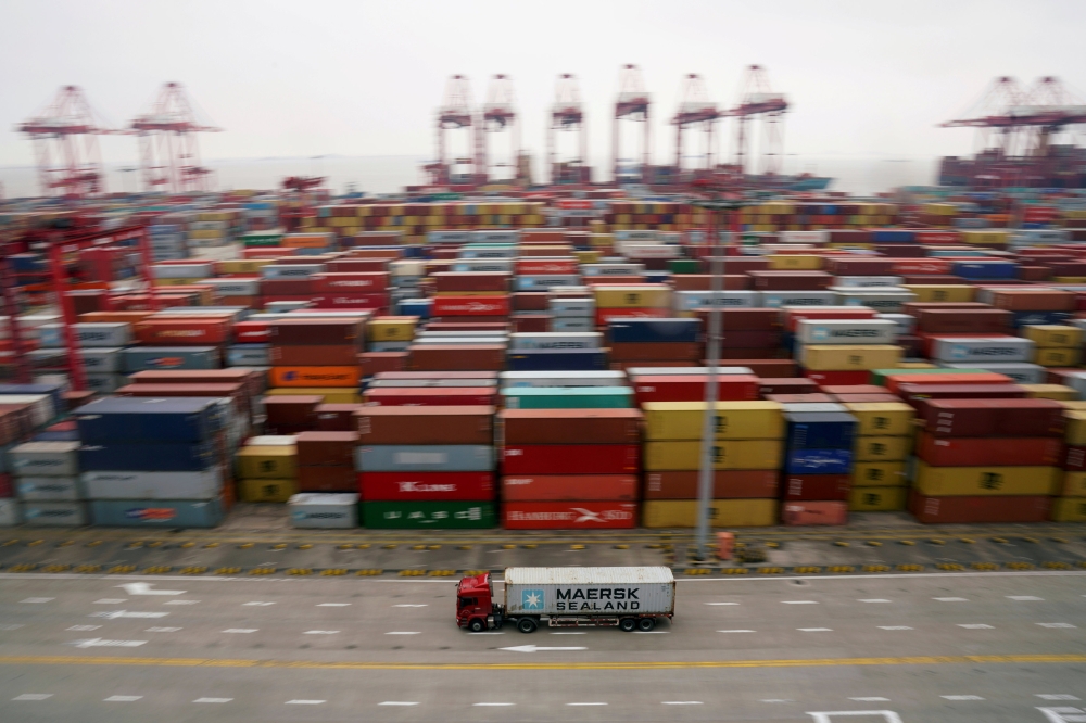 A container truck moves past containers at the Yangshan Deep Water Port in Shanghai, China April 24, 2018. (REUTERS/Aly Song/File Photo) 