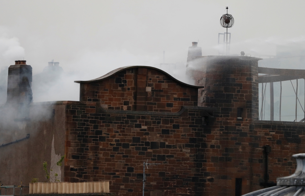 Firefighters attend to a blaze at the Mackintosh Building at the Glasgow School of Art, which is the second time in four years, Glasgow, Scotland, Britain June 16, 2018. REUTERS/Russell Cheyne